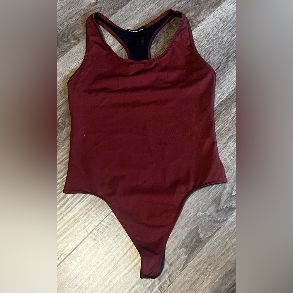 NWOT Koral rust & black racer back bodysuit. Size Medium.